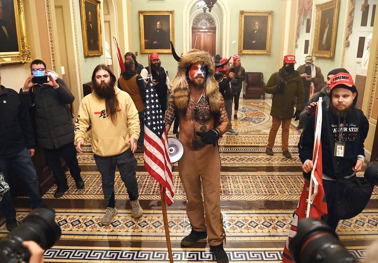 Trump's QAnon Shaman and his fellow insurrectionists invade the U.S. Capitol Building on January 6, 2021